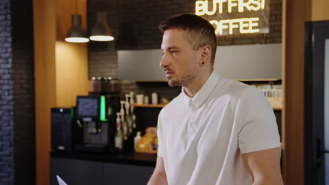 A man thinks about an idea and writes it down in a laptop in the office Stock Footage 219461294