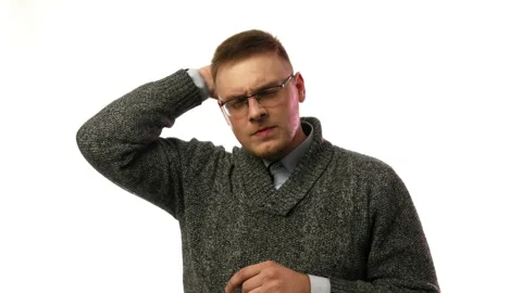 Man thinks about something and then looks at the camera Video stock 93600519