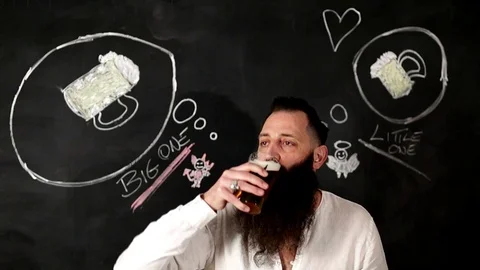 Man thinks about what beer he might drink. Stock Footage 124374562
