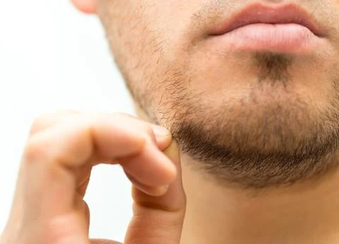 Man thinks shave his beard or not Stock Photos