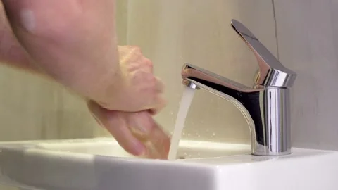 Man thoroughly washes his hands to prevent infection with the virus or bacterium Stock Footage 126673952