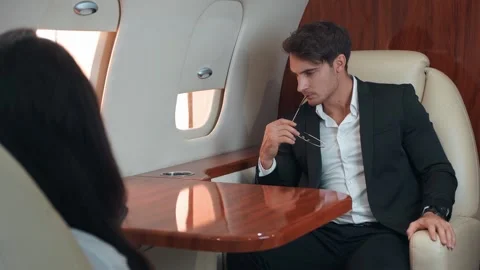 Man thoughtfully looking out airplane window thinking business and work Looking Stock Footage 259795333