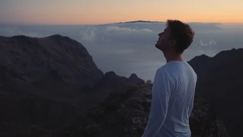 The man thoughtfully looks in the sky on the edge of the earth on top of the Stock Footage 99752707