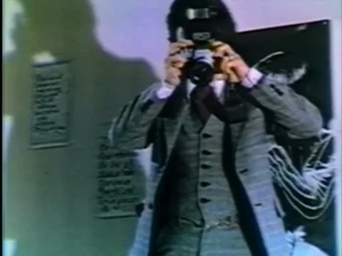 Man in three-piece suit taking a photograph with flash going off, 1970s Stock Footage 65860240