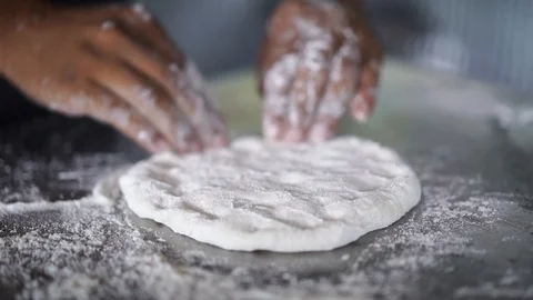 Man thresh flour on stainless surface, prepare to make homemade style pizza Stock Footage 120383690