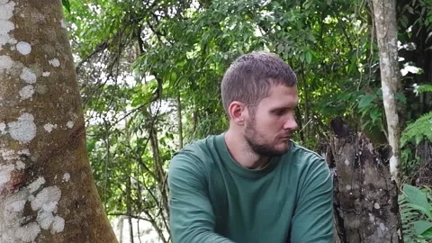 The man threw out an empty urn for the ashes and rolled over a tree and closed h Video stock 158817578