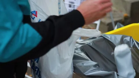 Man throw away plastic bottles in container with bag for garbage recycling Stock Footage 246886049