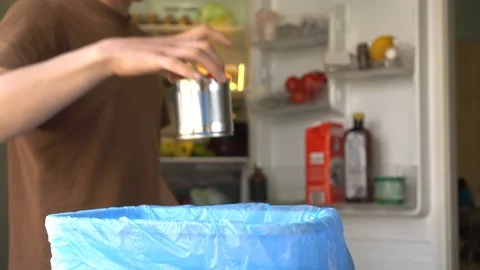 A man throw away spoiled produce from the refrigerator Stock Footage 121493943
