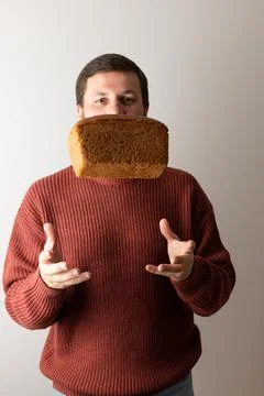 A man throw up a loaf of rye bread into the air. Stock Photos