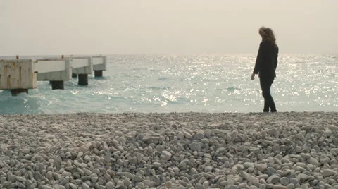 Man throw pebble in seaside on beach 動画素材 64573819