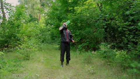 Man throw plastic bottle in nature. Forest pollution Stock Footage 158119735