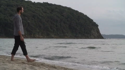 Man throw stick on beach at sunset 動画素材 64558971