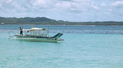 Man throwing anchor from white boat in clean turquoise water Stock Footage 67412607