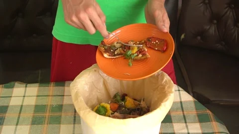 A man throwing away of leftovers at home. Household Food Loss and Food Waste Stock Footage 132631358