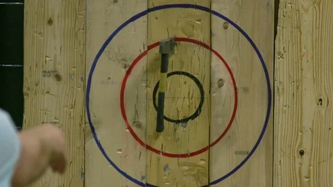Man Throwing Axe and Hitting Wood Target in Slow Motion Video stock 93533394