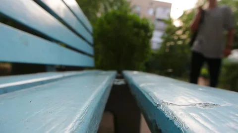 Man throwing a backpack on a bench and sits down 库存影片 67315906