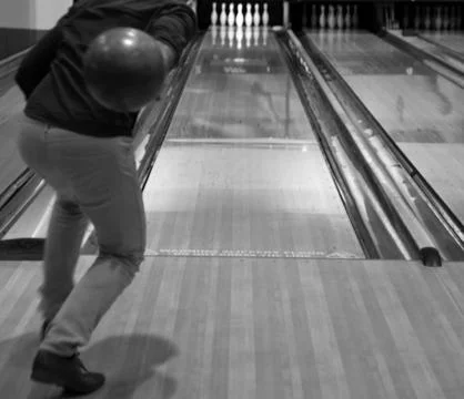Man throwing bowling ball on bowling lane Stock Photos