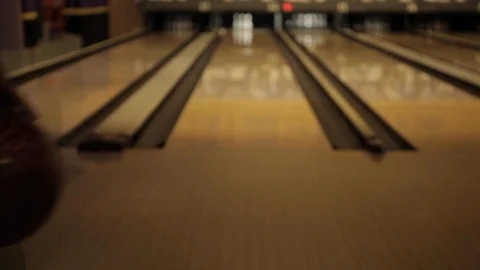 Man Throwing Bowling Ball down Lane Stock Footage 114017329