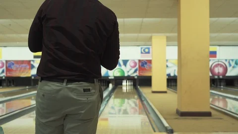 Man throwing bowling ball, playing bowling as weekend activity, Stock Footage 117997698