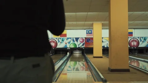 Man throwing bowling ball, playing bowling as weekend activity, Stock Footage 117997706