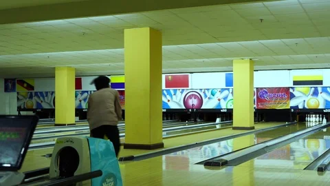 Man throwing bowling ball, playing bowling as weekend activity, Stock Footage 117997717