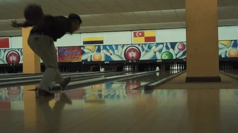 Man throwing bowling ball, playing bowling as weekend activity, Stock Footage 117997722