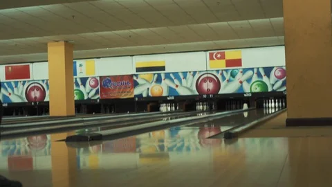 Man throwing bowling ball, playing bowling as weekend activity, Stock Footage 117997802