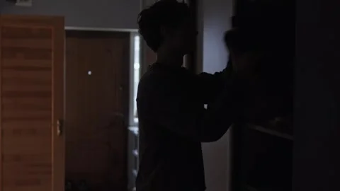 Man throwing clothes from wardrobe in home office. Radical decluttering Stock Footage 327743096