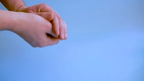 Man throwing colored dice on blue background. Game of dice. The man is mixing a Stock Footage 148999367