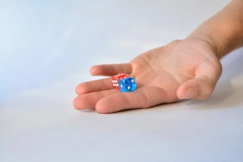 Man throwing colored dice on white background Stock Photos