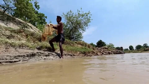 Man throwing fishing net in stream, slow, Stock Video