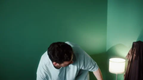 Man throwing garbage from bed into trash bin Vídeos de archivo 319443177