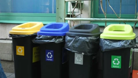 A man throwing paper in public recycle bins. Waste segregation concept. Warsaw Stock-Footage 150568044