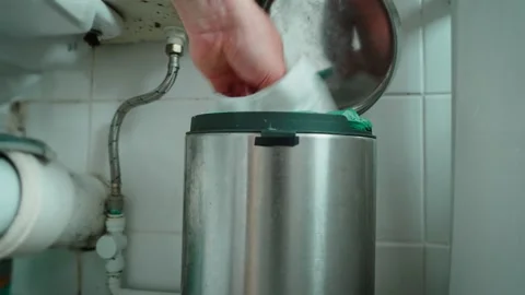 Man throwing paper into waste bin inside dirty public restroom. Close up hand Stock Footage 337640291