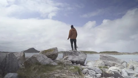 Man throwing a pebble in the sea Stock Footage 85831900