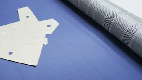 Man Throwing Pieces of Cardboard on a Blue Material Stock Footage 90064147