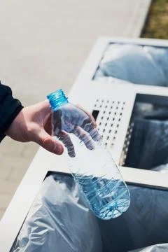 Man throwing a plastic bottle to trash Stock Photos