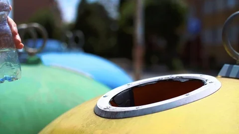 Man throwing plastic, empty bottle into recycling bin Stock Footage 112182971