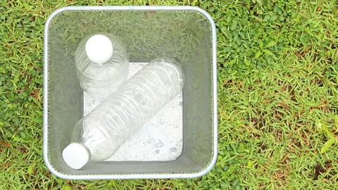 Man throwing  plastic water bottles in to the bin out door  Chiangmai Thailand. Stock Footage 156993886