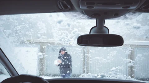 Man throwing snowball on windshield. Windscreen wiper cleaning snow. Video stock 94917898