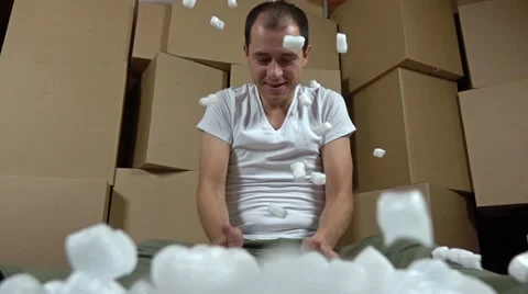 Man throwing soft polystyrene pieces. Shockproof packaging material. Safety Stock Footage
