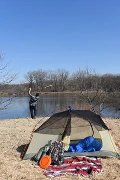 Man Throwing stick into lake Stock Photos