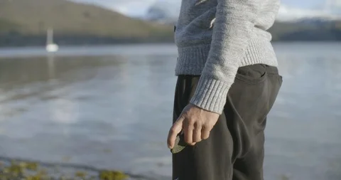 Man throwing stone in river Stock-Footage 85835325