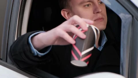 Man throwing trash into the car window, close-up Stock Footage 152090457