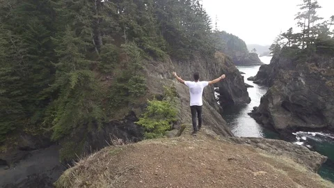 Man Throws Arms Up and Cheers in Oregon Natural Bridges Slow Motion Stock Footage 98863288