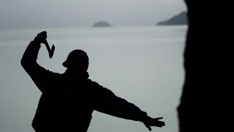 A Man Throws Axe- Silhouette - Slow Motion 動画素材 74432645