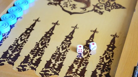 A man throws bones three times at backgammon Stock Footage 129942161