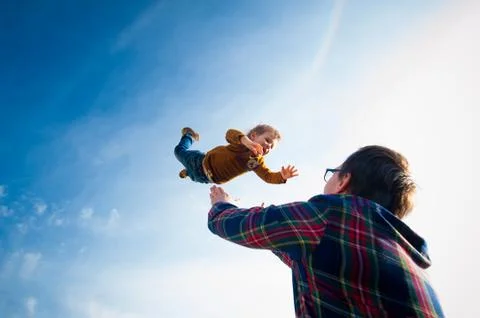 Man throws the boy in the sky Stock Photos