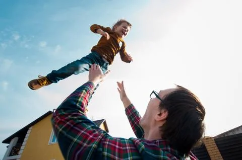 Man throws the boy in the sky Stock Photos