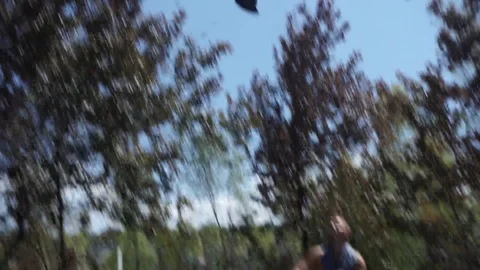 Man throws a cap into the air and tries to catch it but he can't Video stock 102249867